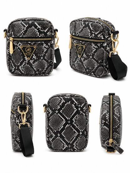 Black and white patterned crossbody bag with gold accents on a white background