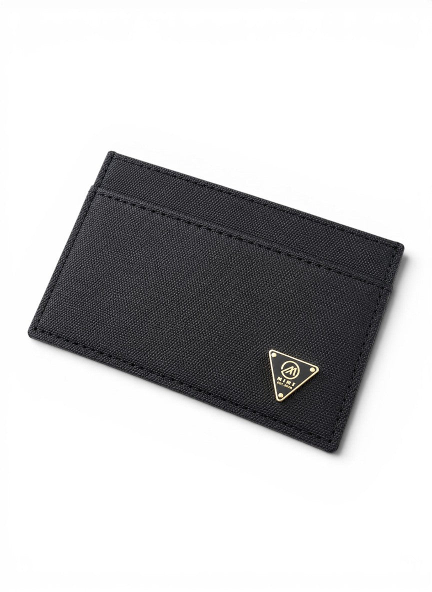 Black cardholder with a gold logo on a white background By Mint Worldwide.