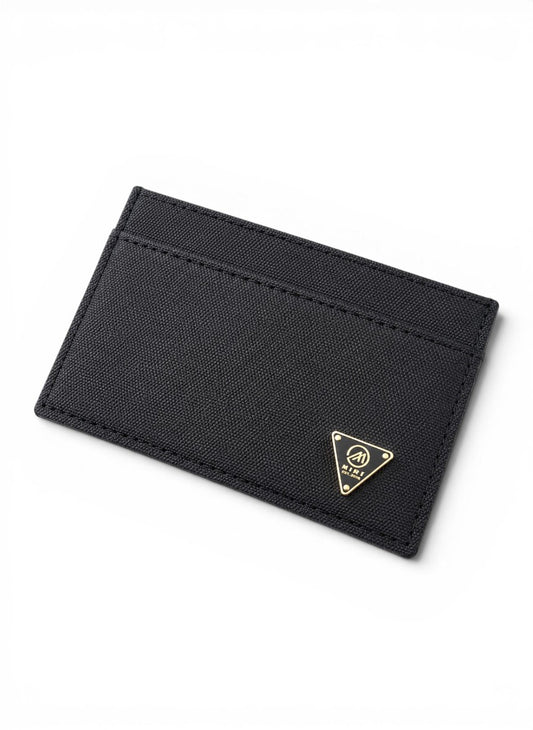 Black cardholder with a gold logo on a white background By Mint Worldwide.