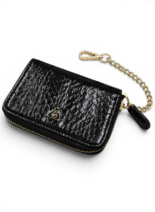 Black textured wallet with gold chain on a white background by Mint Worldwide.