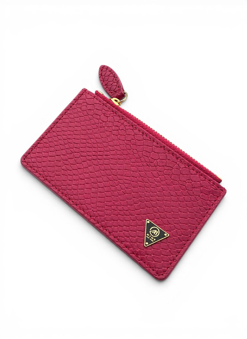 Pink textured pouch with a gold zipper and logo on a white background by Mint Worldwide.