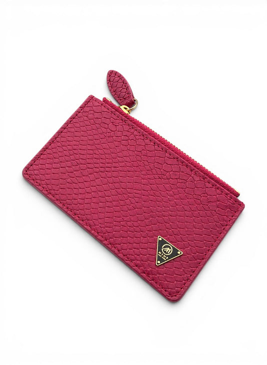 Pink textured pouch with a gold zipper and logo on a white background by Mint Worldwide.