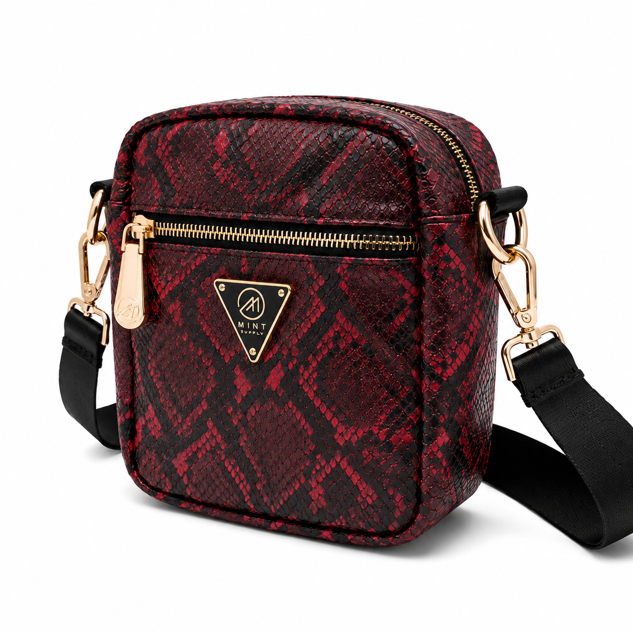Red and black patterned crossbody bag with gold zipper and black strap on a white background