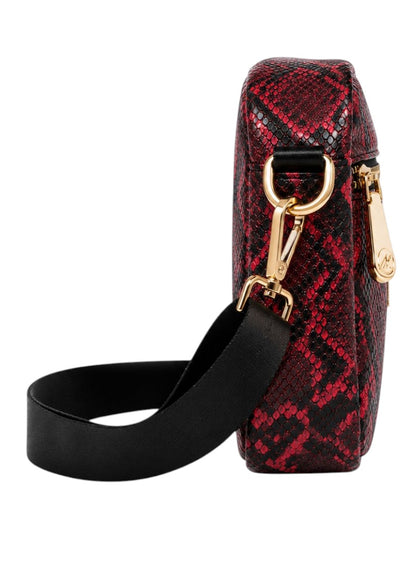 Red snake print handbag with gold hardware and black strap on a white background