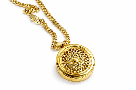 Gold necklace with a intricate pendant on a white background