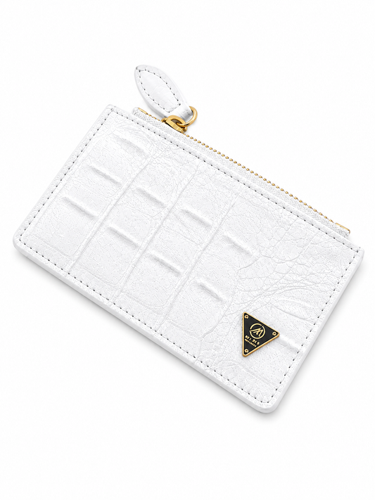 White crocodile-patterned wallet with a gold zipper and logo on a white background by Mint Worldwide.